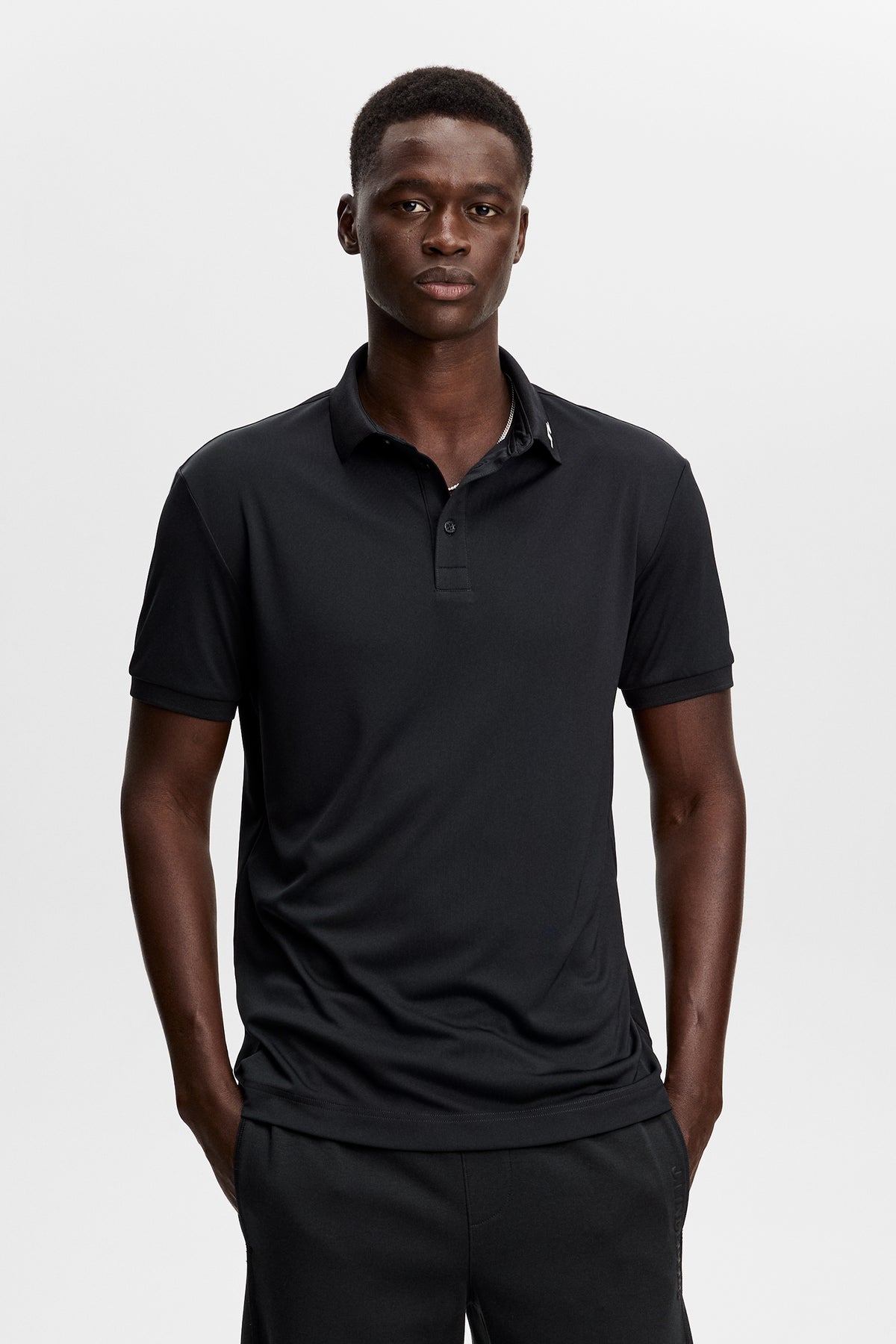 J.Lindeberg KV Print Polo Black – front view showing ribbed collar and three-button placket